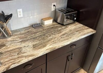 Modern Brown Fantasy Dolomite kitchen countertop with appliances and utensils.