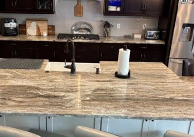 Modern kitchen with Brown Fantasy Dolomite countertop and dark cabinets