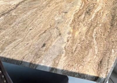 Brown Fantasy Dolomite tabletop with textured chair edges.