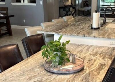 Modern kitchen with Brown Fantasy Dolomite countertop and dining area.