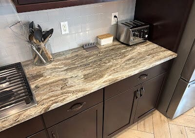 kitchen countertop made with Brown Fantasy Dolomite that matches the dark brown cabinets
