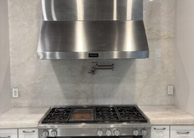 Cristallo Extra Quartzite countertops and full height backsplash to the ceiling