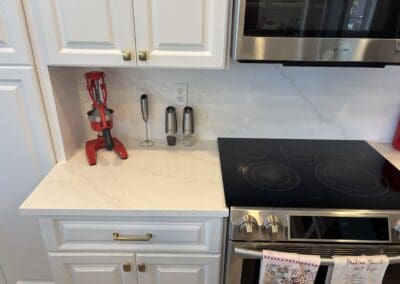 white quartz kitchen countertop and white quartz high backsplash