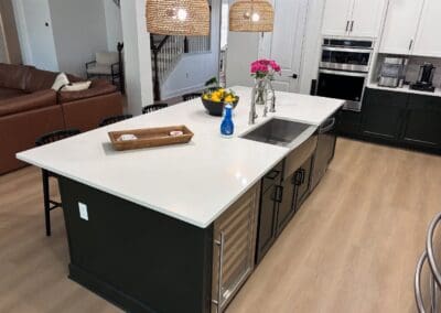 desk with white quartz countertop and waterfall side and a high backsplash.