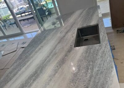 natural stone countertop being installed on a kitchen island