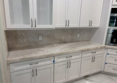large kitchen with Cristallo Extra Quartzite countertops and high backsplash