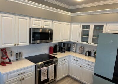 kitchen with white quartz countertop and match white quartz high backsplash