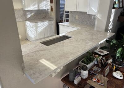 Quartz kitchen countertops with full height backsplash in Tampa by Rock Solid Granite & Marble